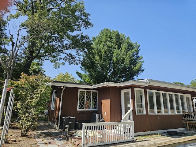 view of front of house with a deck and central AC