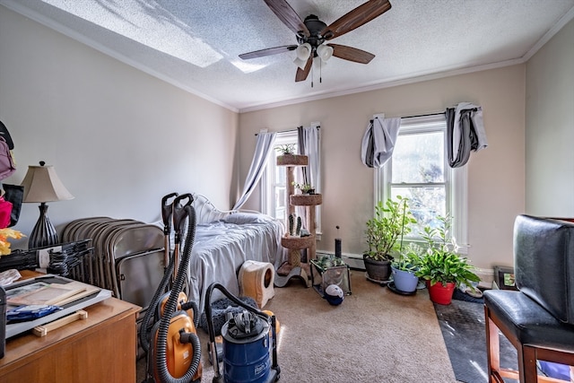 bedroom featuring ceiling fan, crown molding, carpet, and a textured ceiling