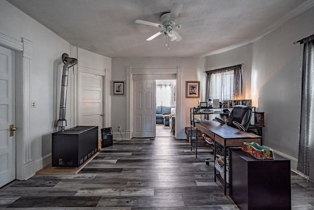 office space featuring a textured ceiling, ceiling fan, and dark wood-type flooring