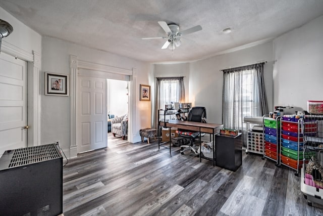 office space with a textured ceiling, dark hardwood / wood-style flooring, and ceiling fan