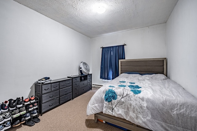 carpeted bedroom with baseboard heating and a textured ceiling