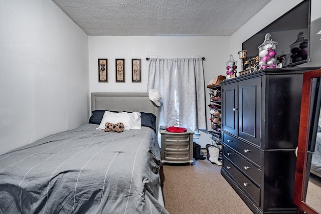 bedroom featuring carpet floors and a textured ceiling