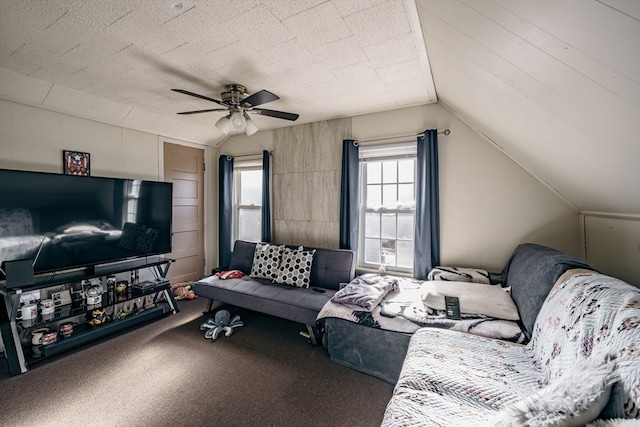 carpeted living room with ceiling fan and vaulted ceiling