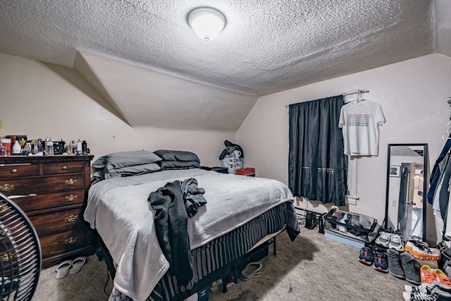 bedroom with carpet, a textured ceiling, and vaulted ceiling