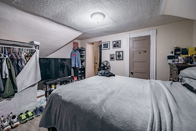 bedroom featuring a textured ceiling, carpet, and vaulted ceiling