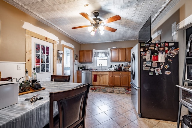 kitchen featuring light tile patterned floors, stainless steel appliances, tile counters, and ceiling fan