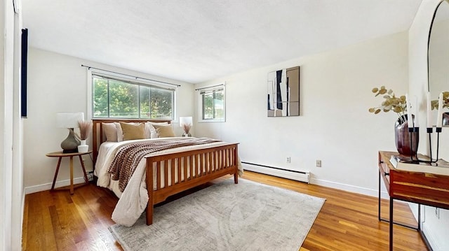 41 Lee Rd, Needham, MA 02494 - bedroom featuring baseboard heating, wood finished floors, and baseboards