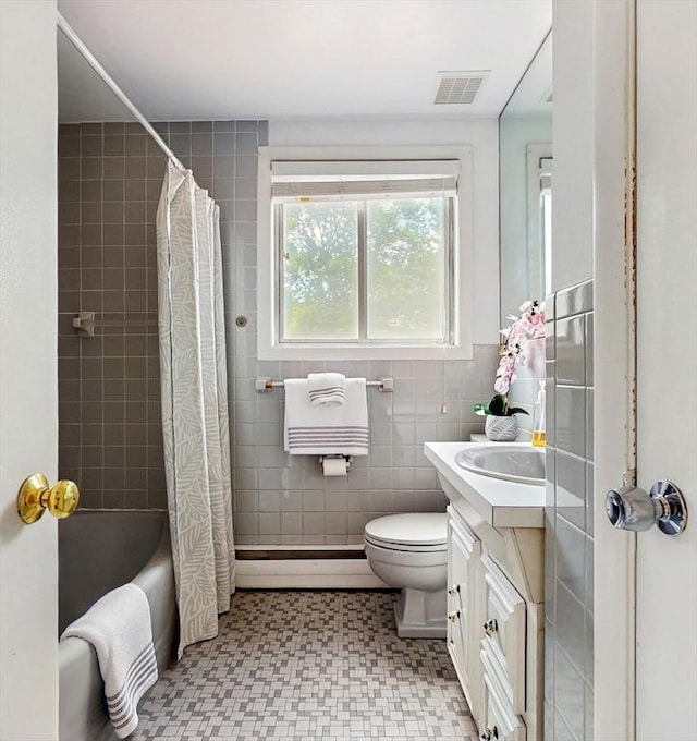 41 Lee Rd, Needham, MA 02494 - full bath featuring a baseboard radiator, vanity, tile walls, toilet, and shower / bath combo with shower curtain