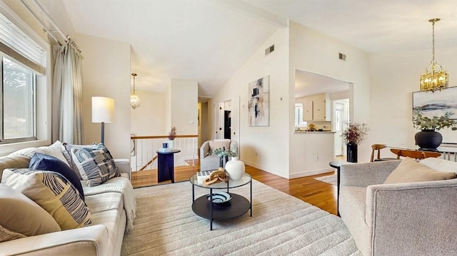 41 Lee Rd, Needham, MA 02494 - living room featuring a chandelier, wood finished floors, vaulted ceiling, and baseboards