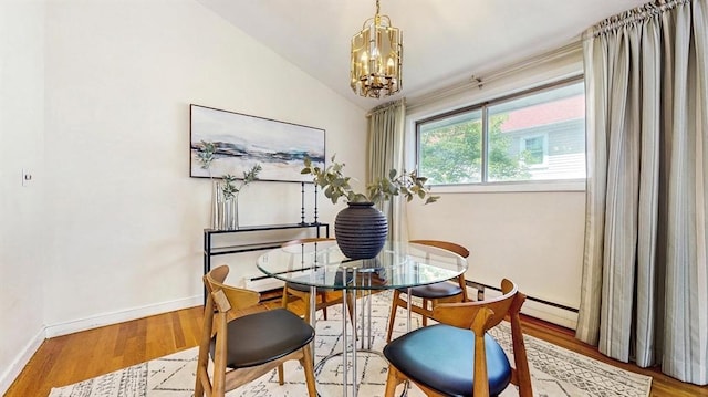 41 Lee Rd, Needham, MA 02494 - dining area with a chandelier, wood finished floors, baseboards, and vaulted ceiling