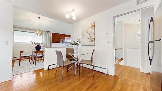 41 Lee Rd, Needham, MA 02494 - dining room with light wood finished floors, a chandelier, and baseboard heating