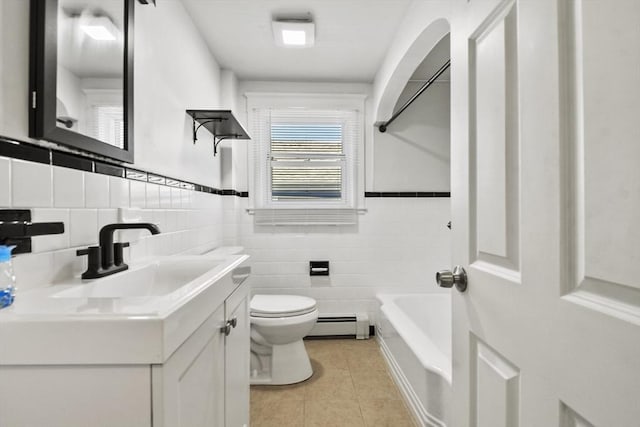 27 Whittier St, Fall River, MA 02724 - bathroom featuring tile patterned flooring, a tub, vanity, a wainscoted wall, and tile walls