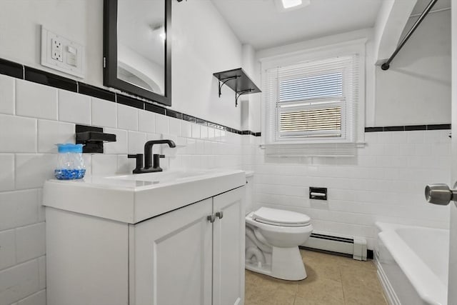 27 Whittier St, Fall River, MA 02724 - full bath featuring baseboard heating, tile walls, tile patterned floors, vanity, and a tub to relax in