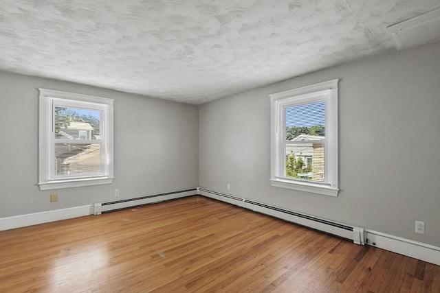 27 Whittier St, Fall River, MA 02724 - spare room featuring a baseboard radiator, wood-type flooring, and a textured ceiling