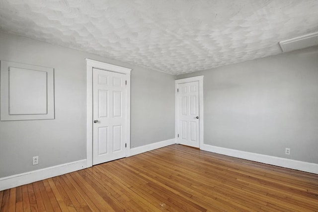 27 Whittier St, Fall River, MA 02724 - unfurnished bedroom featuring hardwood / wood-style floors and a textured ceiling