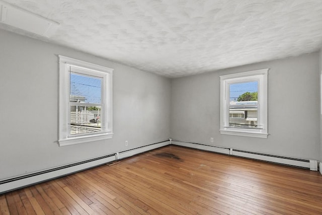 27 Whittier St, Fall River, MA 02724 - empty room featuring a textured ceiling, hardwood / wood-style flooring, and a baseboard radiator
