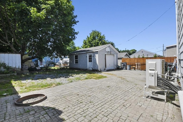 27 Whittier St, Fall River, MA 02724 - back of property with an outdoor structure and a garage