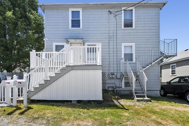 27 Whittier St, Fall River, MA 02724 - back of property featuring stairway and a lawn