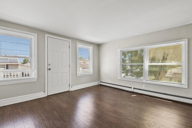 27 Whittier St, Fall River, MA 02724 - entrance foyer with a baseboard heating unit, plenty of natural light, and wood finished floors