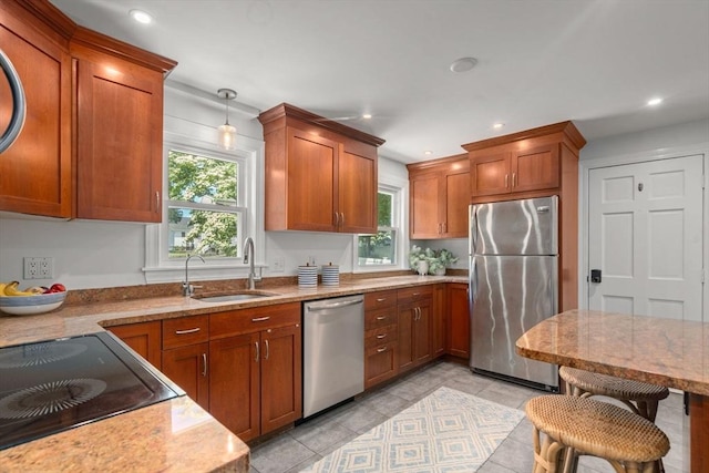 11 Netta Rd, Dedham, MA 02026 - kitchen featuring appliances with stainless steel finishes, a sink, brown cabinets, light stone countertops, and recessed lighting