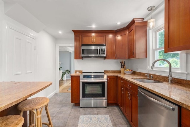 11 Netta Rd, Dedham, MA 02026 - kitchen with appliances with stainless steel finishes, a sink, light stone counters, recessed lighting, and brown cabinetry