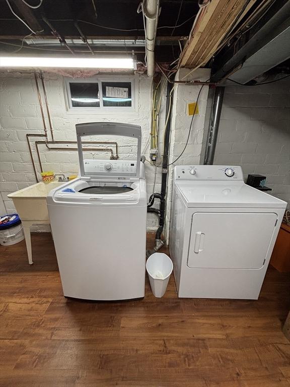 259 Gillette Ave, Springfield, MA 01118 - laundry room with washer and clothes dryer, wood finished floors, and concrete block wall