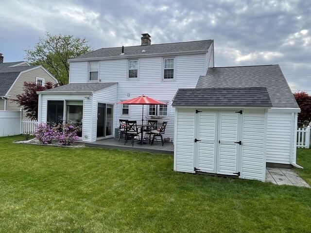 259 Gillette Ave, Springfield, MA 01118 - rear view of property featuring a shingled roof, a chimney, and outdoor dining area