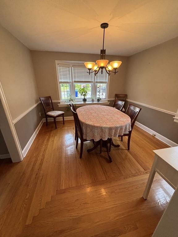 259 Gillette Ave, Springfield, MA 01118 - dining area featuring a chandelier, wood finished floors, and baseboards