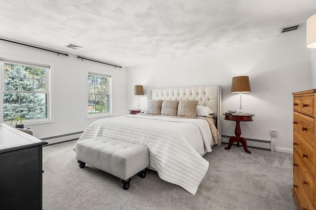 bedroom featuring a baseboard radiator, carpet flooring, and visible vents