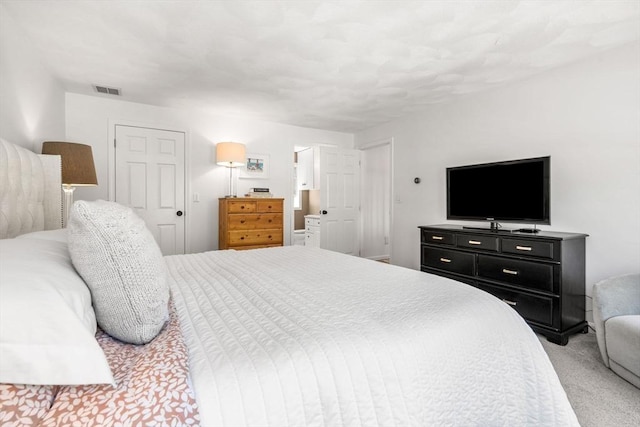 bedroom featuring light carpet and visible vents