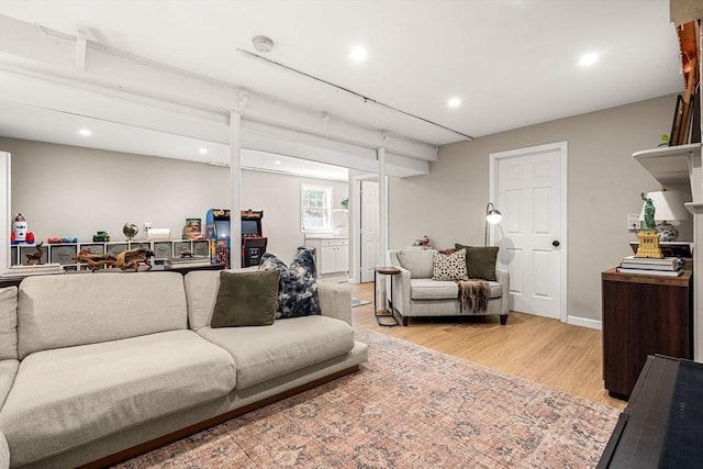 living area with light wood-style floors and recessed lighting