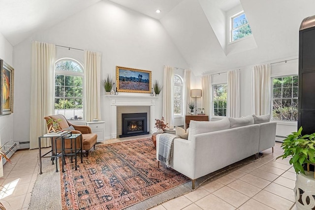 living area with light tile patterned floors, high vaulted ceiling, plenty of natural light, and a warm lit fireplace