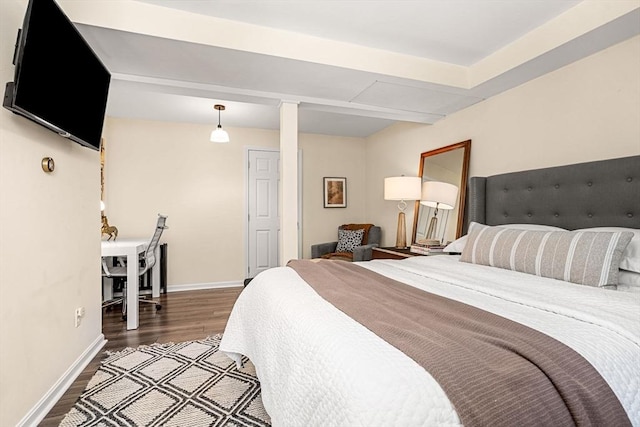 bedroom featuring baseboards and wood finished floors