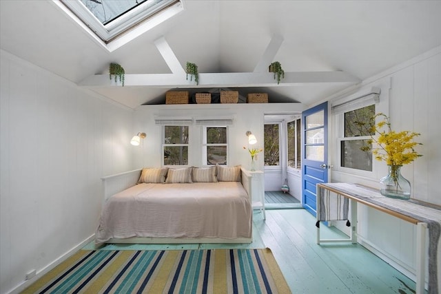82 Shore Rd Unit 9, Truro, MA 02652 - bedroom with a skylight, hardwood / wood-style flooring, vaulted ceiling, and a decorative wall