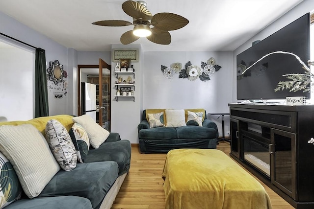 living room featuring ceiling fan and light wood-type flooring
