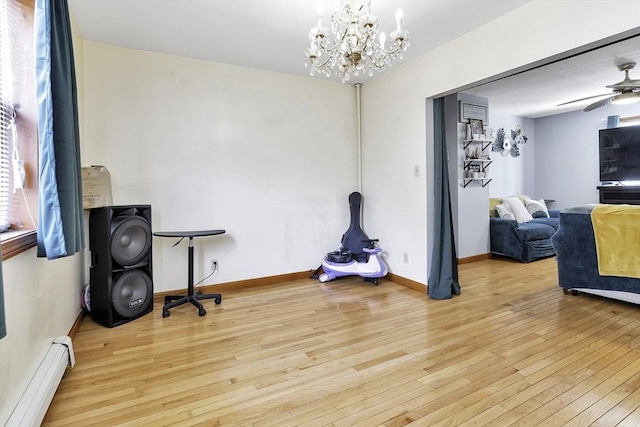 miscellaneous room featuring hardwood / wood-style flooring, baseboards, baseboard heating, and ceiling fan with notable chandelier