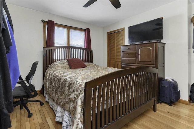 bedroom with a closet, light wood-type flooring, and a ceiling fan
