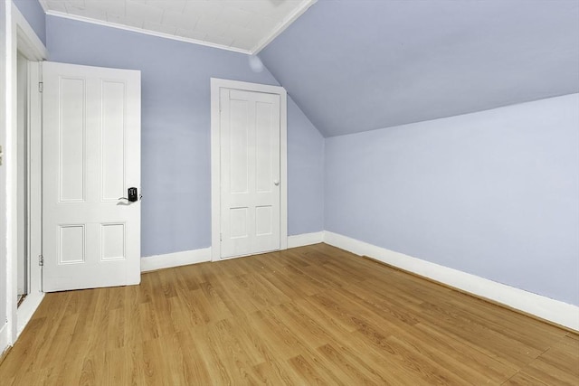 bonus room featuring vaulted ceiling, baseboards, and light wood-type flooring