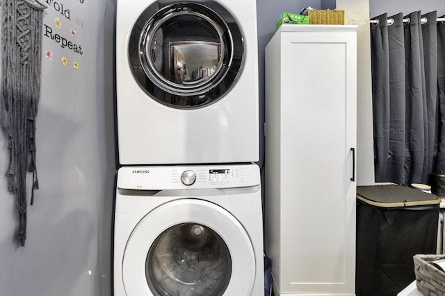 laundry area featuring stacked washing maching and dryer and laundry area