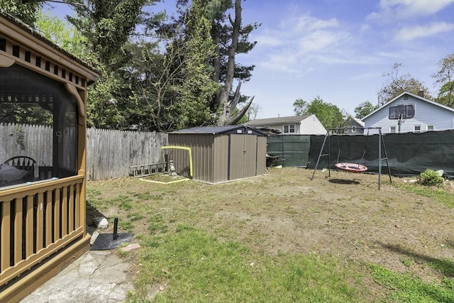 view of yard with an outbuilding, a shed, and a fenced backyard