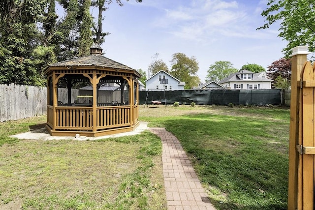 view of yard featuring a gazebo and a fenced backyard
