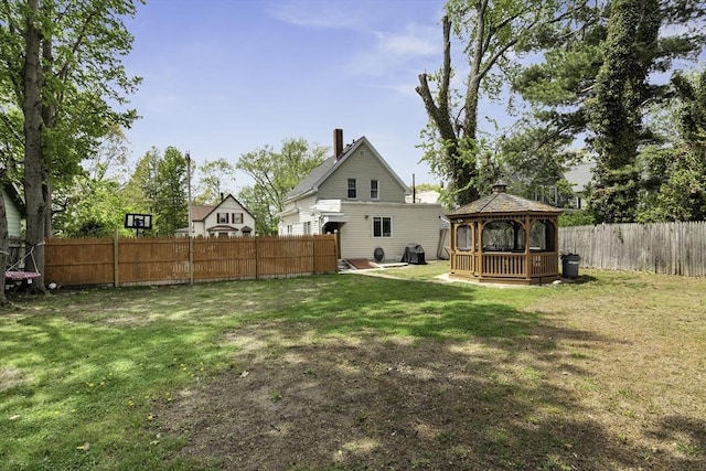 view of yard featuring a gazebo and a fenced backyard