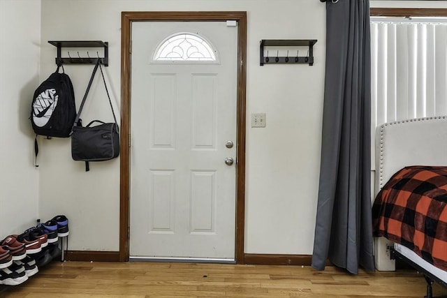 foyer with light wood-type flooring and baseboards