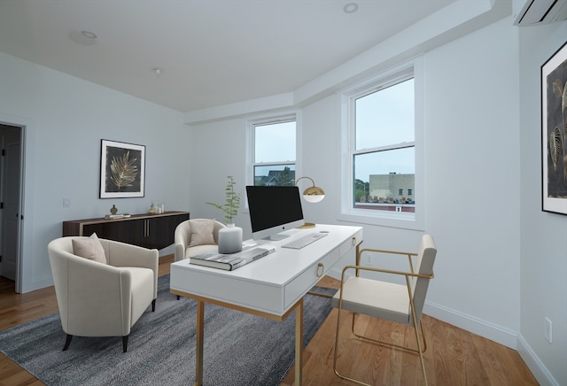 office featuring a wall unit AC and hardwood / wood-style flooring