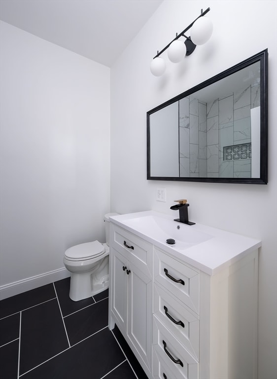 bathroom with tile patterned flooring, toilet, and vanity