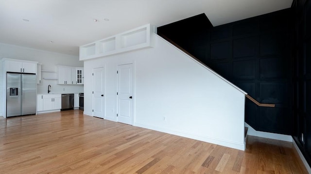 interior space with a sink and light wood finished floors