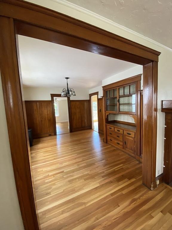 295 Atlantic, Quincy, MA 02171 - unfurnished living room with a chandelier and light wood finished floors