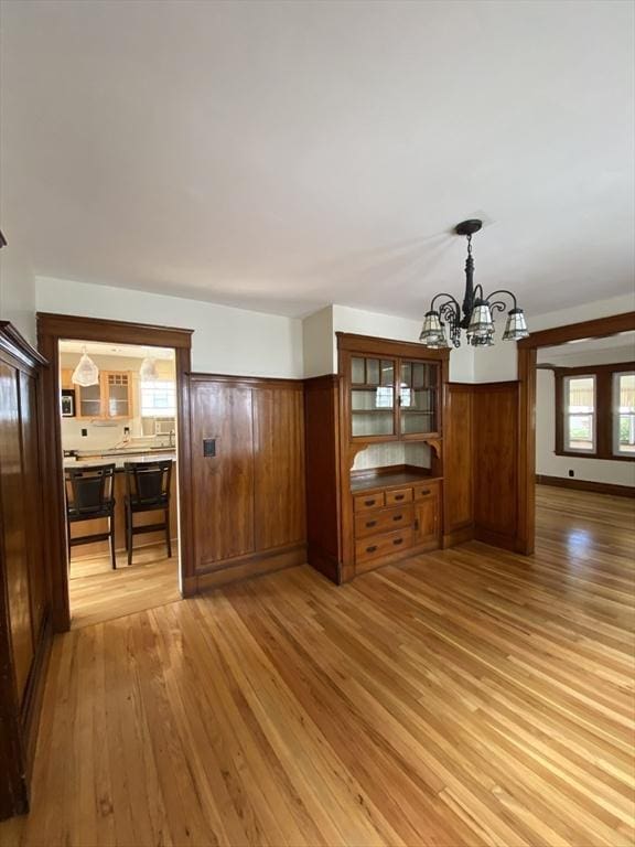 295 Atlantic, Quincy, MA 02171 - unfurnished living room with light wood-style flooring, a chandelier, and healthy amount of natural light