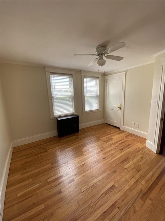 295 Atlantic, Quincy, MA 02171 - unfurnished bedroom with light wood finished floors, ornamental molding, and ceiling fan