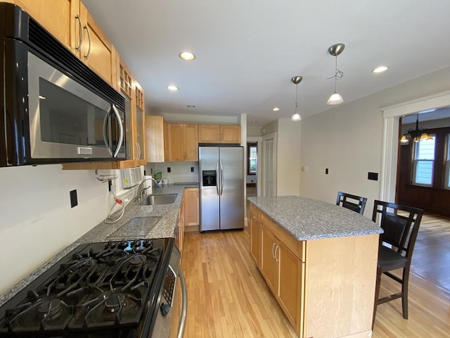 295 Atlantic, Quincy, MA 02171 - kitchen featuring appliances with stainless steel finishes, light wood-type flooring, recessed lighting, a kitchen island, and light stone counters
